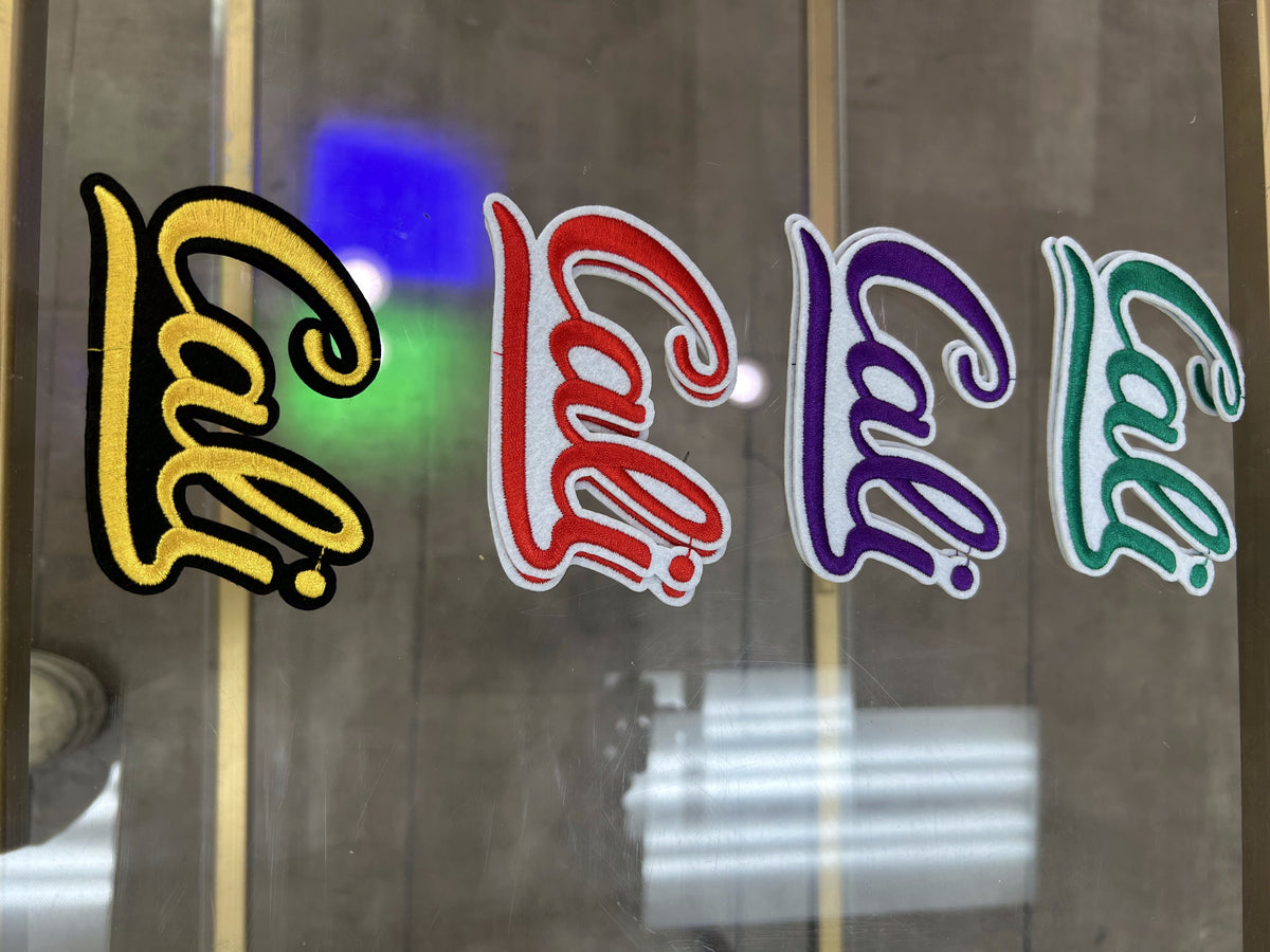 Cali cursive patches in yellow, red, purple, and teal